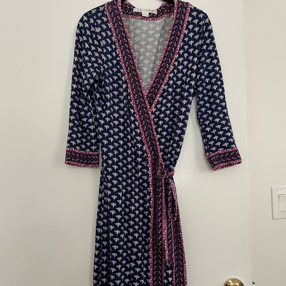 DVF navy blue patterned wrap dress with pink patterned trim.